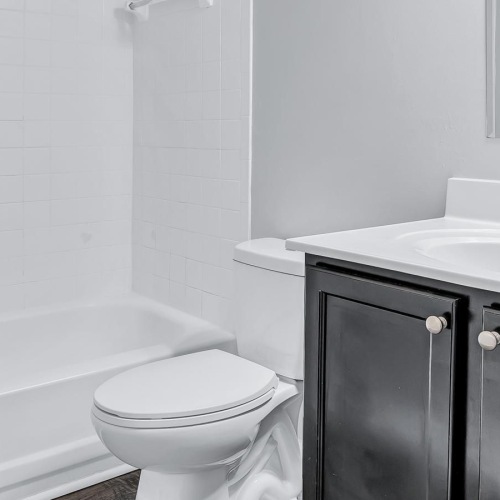 a bathroom with a mirror tub toilet and sink