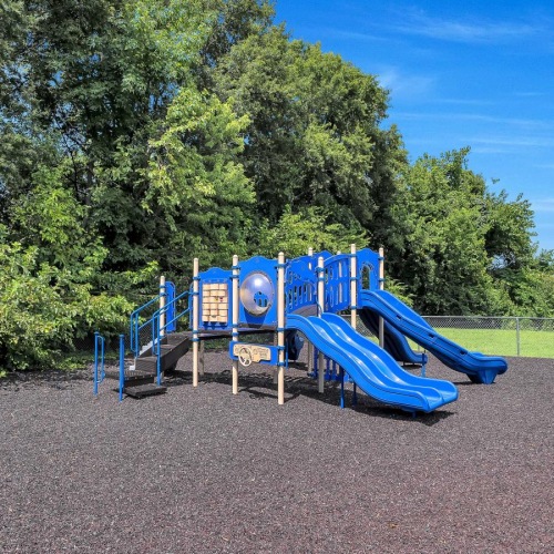 a playground with trees in the background
